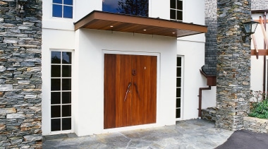 View of front entranceway of home with plaster building, door, facade, home, house, real estate, window, gray