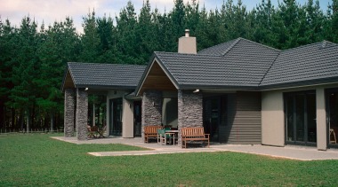 Exterior view of home with schist stone columns cottage, elevation, estate, facade, farmhouse, grass, home, house, landscape, outdoor structure, property, real estate, residential area, roof, siding, window, yard, green