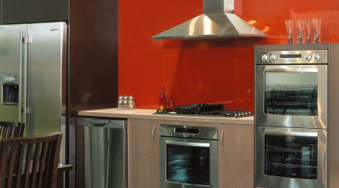 Kitchen with orange splashback, stainless steel refrigerator, dishwasher, cabinetry, countertop, cuisine classique, home appliance, interior design, kitchen, kitchen appliance, kitchen stove, major appliance, oven, black, red