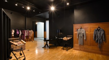 A view of a retail store. - A boutique, ceiling, floor, flooring, interior design, wood flooring, black