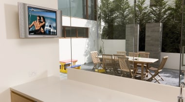 Kitchen with white benchtop, wall mounted tv screen, countertop, furniture, interior design, product design, table, white