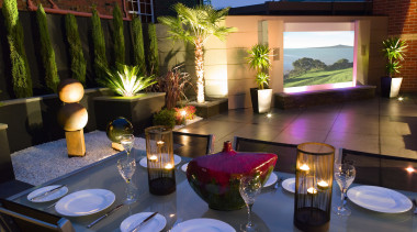 view of the outdoor dining area featuring alluminium home, lighting, black