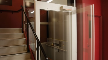 View of lift with glass door and sides, architecture, floor, handrail, interior design, stairs, red, brown
