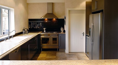 A view of a kitchen designed by Pauline cabinetry, countertop, cuisine classique, floor, flooring, home appliance, interior design, kitchen, real estate, room, brown, white