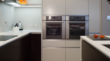 view of the kitchen featuring a seperate scullery, cabinetry, countertop, home appliance, interior design, kitchen, major appliance, room, gray, black