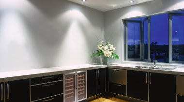 Kitchen with dark cabinetry and white benchtop, with cabinetry, ceiling, countertop, floor, flooring, interior design, kitchen, lighting, room, gray