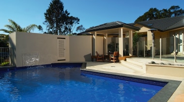 A view of a swimming pool by Mayfair backyard, estate, facade, home, house, leisure, property, real estate, residential area, resort, swimming pool, villa, blue