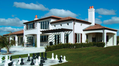 A view of a home by Paul Williams cottage, elevation, estate, home, house, mansion, property, real estate, sky, villa, teal