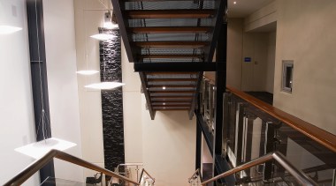 A view of the Trends Building. - A apartment, architecture, ceiling, daylighting, handrail, interior design, stairs, wood, black, brown