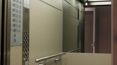 view of the grey tinted mirrors, and custom elevator, glass, brown, black