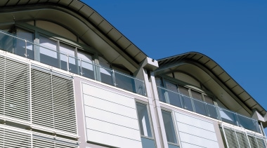 view of the saunders wharf apartments featuring crips architecture, building, commercial building, corporate headquarters, daylighting, daytime, facade, house, line, metropolitan area, residential area, roof, siding, sky, structure, window, blue, white