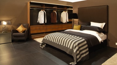 view of the master bedroom featuring timber veneer bed, bed frame, bedroom, floor, flooring, furniture, interior design, room, suite, black, brown