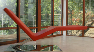 view of this minimalist lounge featuring a white chair, furniture, glass, outdoor furniture, table, window, gray