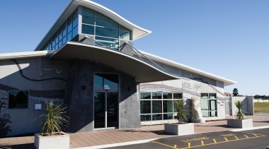 A view of the Papamoa Library designed by architecture, building, commercial building, corporate headquarters, house, real estate, teal, black