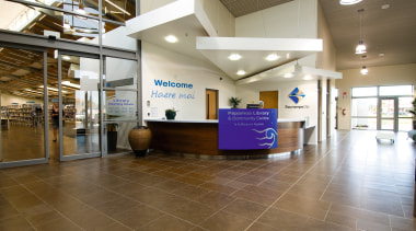 A view of the Papamoa Library constructed by ceiling, floor, flooring, institution, interior design, lobby, real estate, brown, white