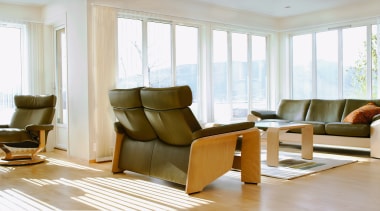 A view of some furniture from Scansin International. chair, floor, flooring, furniture, hardwood, home, interior design, living room, real estate, room, table, window, window covering, wood, wood flooring, white, gray