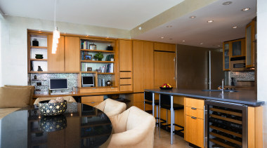 View of the kitchen and dining area featuring cabinetry, countertop, interior design, kitchen, living room, real estate, room