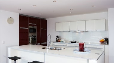 Spanish Red lacquered cabinets contrast with pure white apartment, architecture, ceiling, floor, furniture, house, interior design, kitchen, real estate, table, white