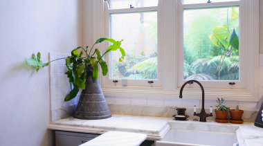 Interior view of laundry featuring fold-away ironing board bathroom, countertop, daylighting, home, house, interior design, kitchen, room, sink, window, gray
