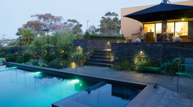 A view of the pool feauting an infinty architecture, backyard, estate, home, house, leisure, lighting, property, real estate, reflection, resort, swimming pool, villa, water, teal, blue