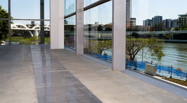 A viewof some polished concrete flooring by ACO apartment, architecture, building, condominium, floor, flooring, real estate, reflection, sky, walkway, water, window, gray