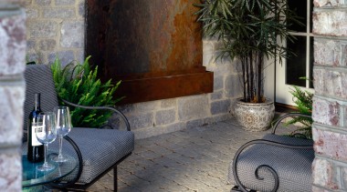 View of patio area with sandstone coloured pavers, brick, courtyard, facade, home, outdoor structure, patio, porch, walkway, wall, window, gray