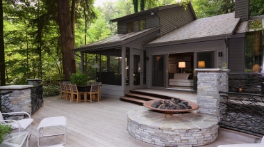 An exterior view of the patio area. - backyard, cottage, deck, home, house, outdoor structure, patio, real estate, yard, black, gray