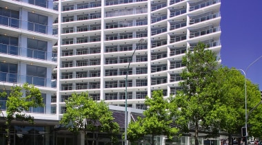 A view of the Volt Apartments. - A apartment, architecture, building, city, commercial building, condominium, corporate headquarters, daytime, facade, headquarters, metropolis, metropolitan area, mixed use, real estate, residential area, sky, skyscraper, tower block, tree, urban area, gray