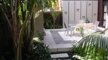 A view of some landscaping by LIANZ. - arecales, backyard, courtyard, garden, grass, home, house, landscaping, outdoor structure, palm tree, patio, plant, property, real estate, walkway, yard, black, gray