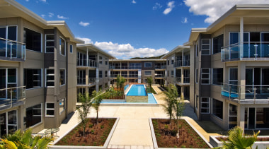 View of the outdoor area of the apartment apartment, building, condominium, corporate headquarters, estate, home, hotel, mansion, mixed use, property, real estate, residential area, resort, villa