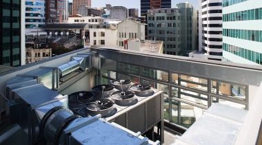 view of the rooftop featuring a 350KW heat building, city, condominium, downtown, metropolis, metropolitan area, roof, urban area, black, white