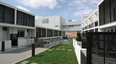 A view of the quality designed apartment complexes apartment, architecture, building, corporate headquarters, facade, home, house, mixed use, neighbourhood, property, real estate, residential area, black, white