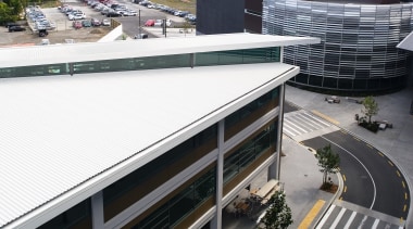 View of this commercial office centre, buidings featuring architecture, building, city, infrastructure, metropolitan area, real estate, road, roof, sky, transport, urban area, white, black