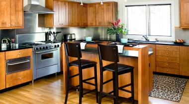 A view of this kitchen featuring stained timber cabinetry, countertop, cuisine classique, floor, flooring, hardwood, interior design, kitchen, laminate flooring, room, wood, wood flooring, white, orange