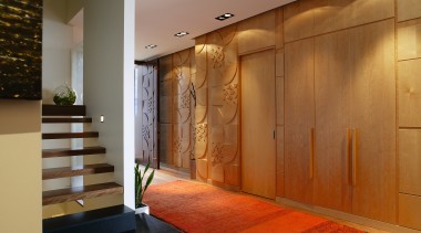 A view of the internal living areas featuring ceiling, door, floor, flooring, hardwood, interior design, lobby, wall, wood, wood flooring, wood stain, brown