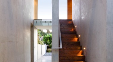 A view of a wooden staircase.  lights, architecture, daylighting, house, interior design, stairs, gray