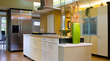 A view of this modern kitchen designed by cabinetry, ceiling, countertop, floor, flooring, hardwood, interior design, kitchen, laminate flooring, wood flooring, orange