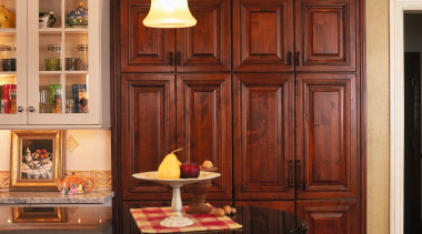 View of this traditional designed kitchen featuring granite cabinetry, countertop, cuisine classique, dining room, furniture, interior design, kitchen, room, shelving, table, wall, window, red