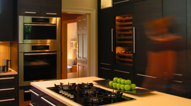 A view of this kitchen features cabinets by cabinetry, countertop, home appliance, interior design, kitchen, room, black, brown