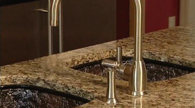 A view of this kitchen featuring a JSG countertop, plumbing fixture, sink, tap, brown