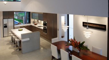A view of the kitchen area featuring polished furniture, interior design, living room, product design, table, gray