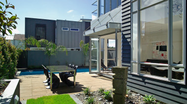 A view of a home designed and built apartment, architecture, backyard, condominium, courtyard, facade, home, house, property, real estate, residential area