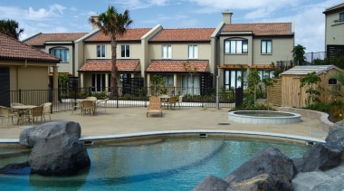 A view of some homes waterproofed by Terracon backyard, cottage, estate, home, house, mansion, outdoor structure, property, real estate, residential area, resort, swimming pool, villa, teal, gray