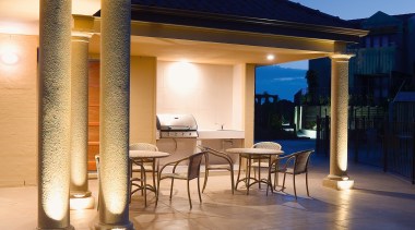 A view of some electrical work done by backyard, column, estate, evening, home, landscape lighting, lighting, outdoor structure, patio, property, real estate, sky, swimming pool, villa, blue