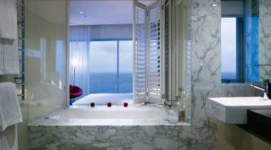 A view of the bathroom featuring marble tiles, bathroom, interior design, room, suite, gray