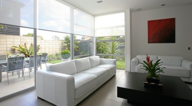 A view of these living areas featuring stained architecture, floor, interior design, living room, property, real estate, window, white, gray