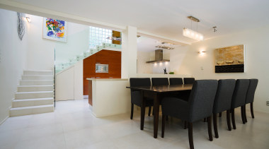 In this homes living space, clsaaical finishes and apartment, architecture, ceiling, dining room, floor, flooring, house, interior design, property, real estate, room, table, gray