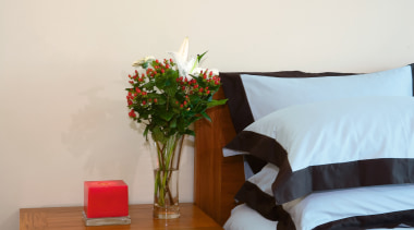 A view of some nedroom furniture from East bed, bed frame, bedroom, floor, furniture, home, house, interior design, nightstand, room, table, wood, white