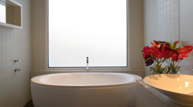 The bathroom has a streamlined and contemporary look, bathroom, bathroom accessory, interior design, plumbing fixture, room, sink, toilet seat, window, gray