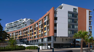 An exterior view of the discovery point apartment apartment, building, city, commercial building, condominium, corporate headquarters, elevation, facade, home, hotel, metropolitan area, mixed use, neighbourhood, property, real estate, residential area, sky, tower block, blue, black